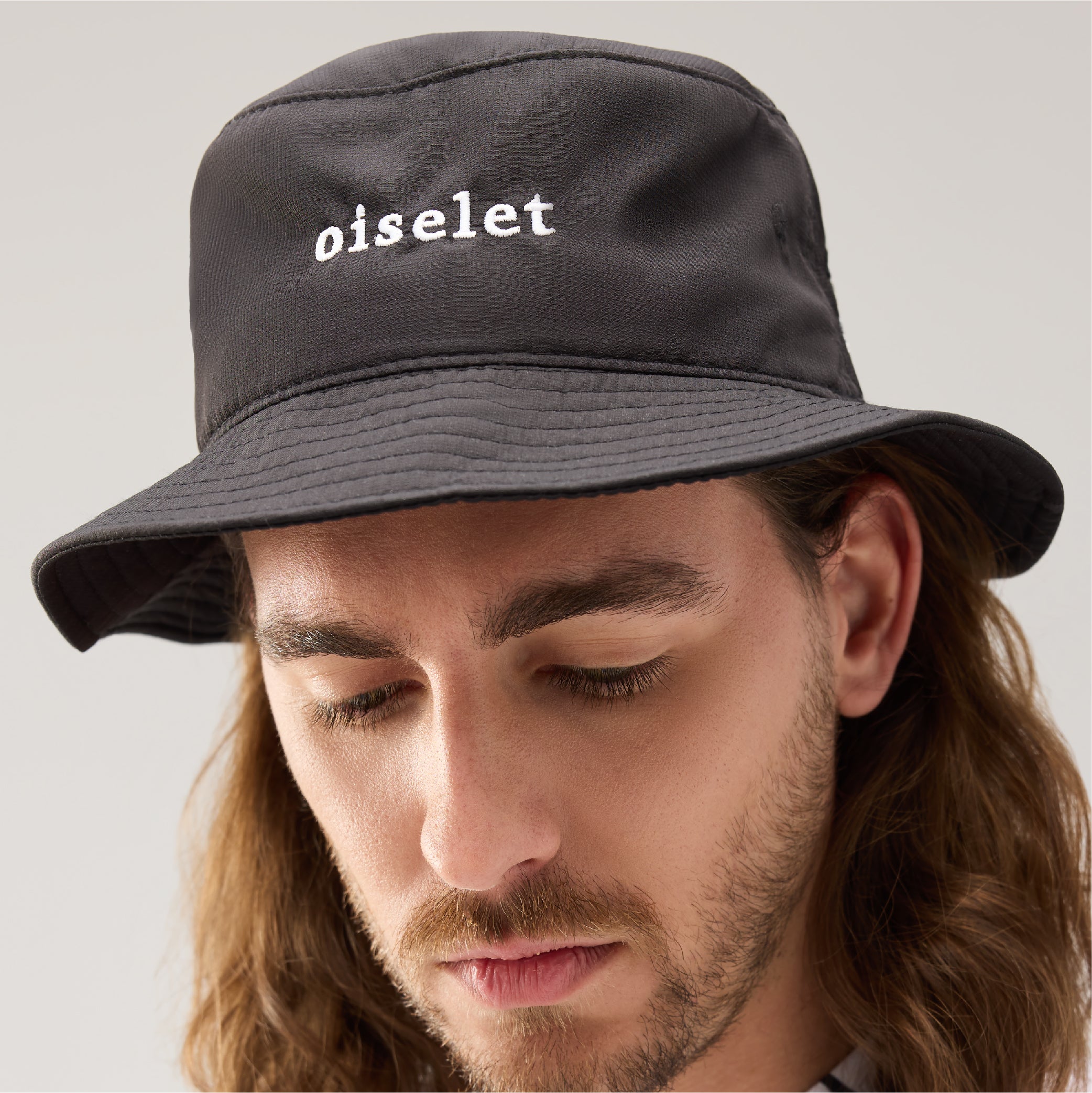 Lecolet Golf bucket hat in black with the word oiselet embroidered on the front