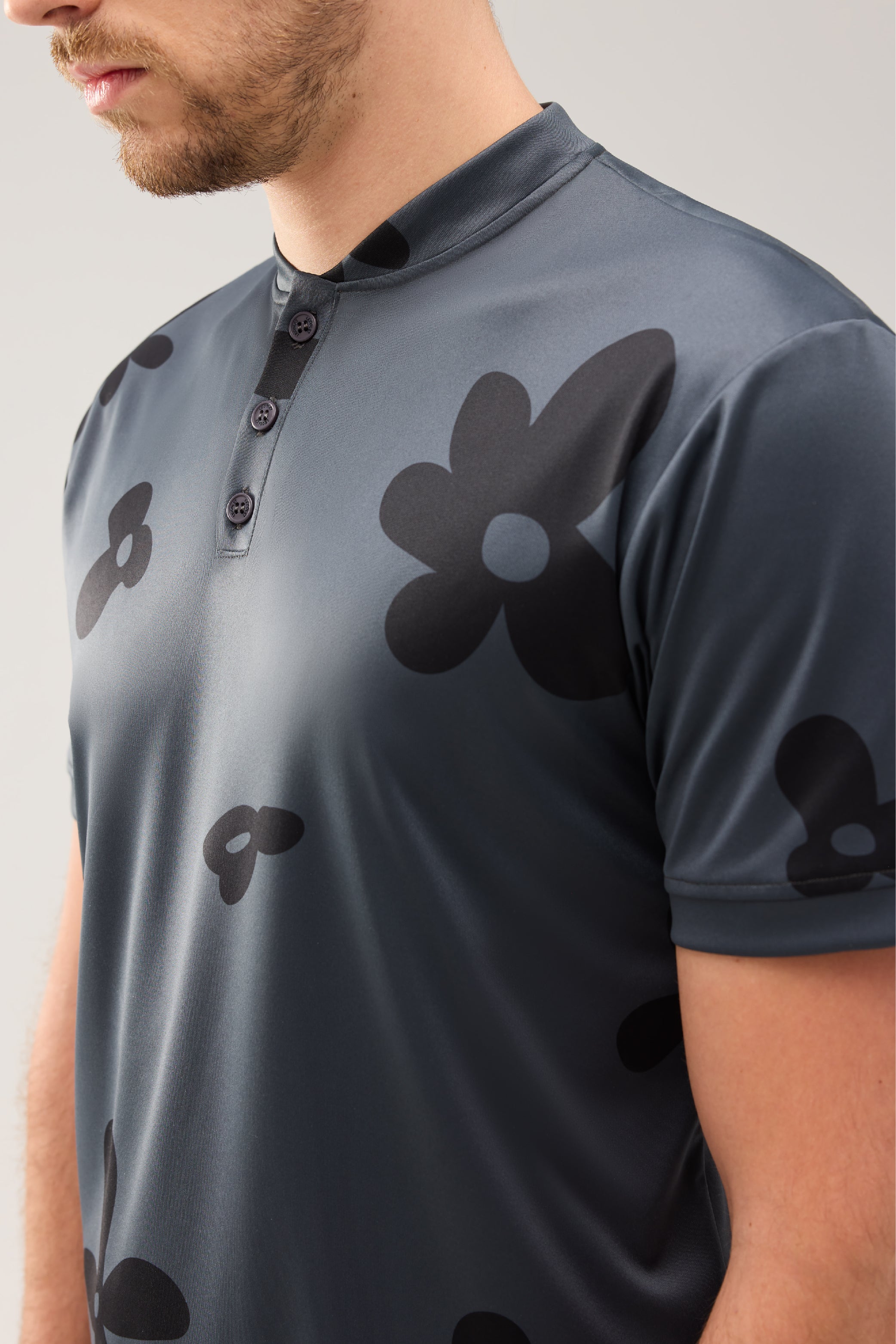 Lecolet SEED golf polo Night Bloom. Dark grey golf polo with darker flower design.